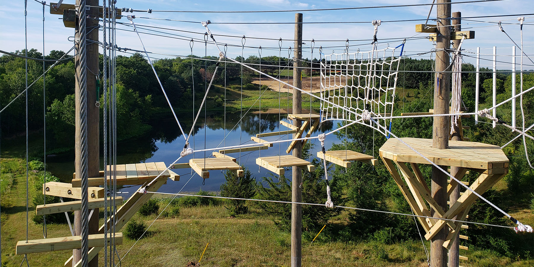 Aerial, canopy rope bridge challenge course with platforms designed and built by ABEE Inc. in Lakeville, Minnesota.