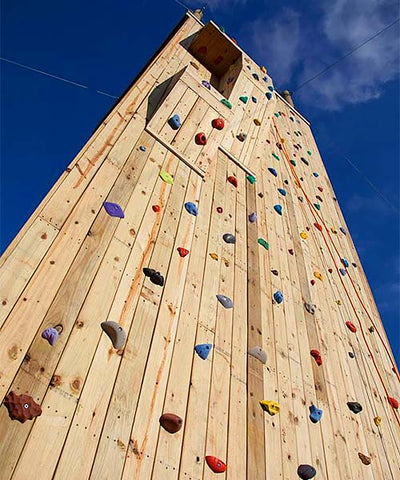 Standing at the base and looking up a large climbing tower designed and built by ABEE Inc.