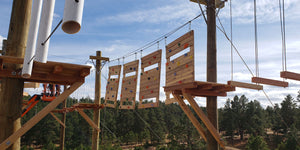 Challenge course with high elements, ropes course, and climbing wall designed and built by ABEE Inc. in Colorado.