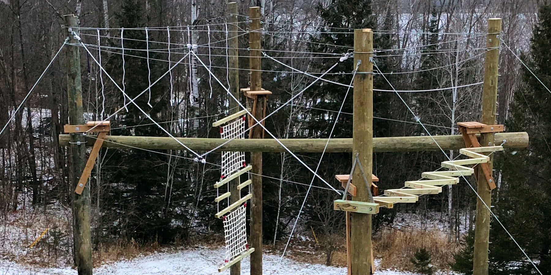Challenge course with high and low elements designed and built by ABEE Inc. in the woods.