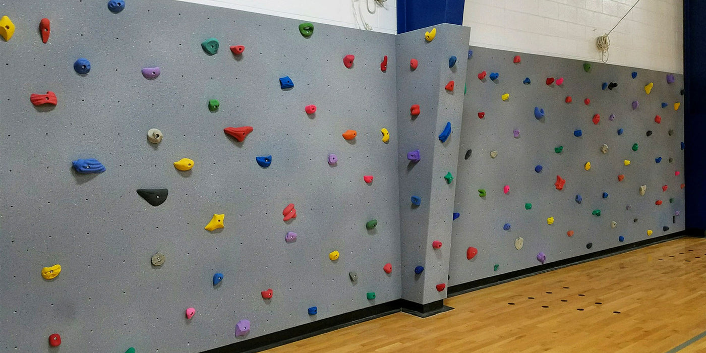 Indoor climbing wall / boulder wall designed and built by ABEE Inc. in a school gym.